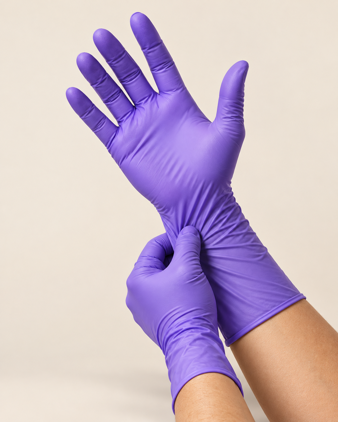Hands pulling on purple chemo-rated nitrile gloves